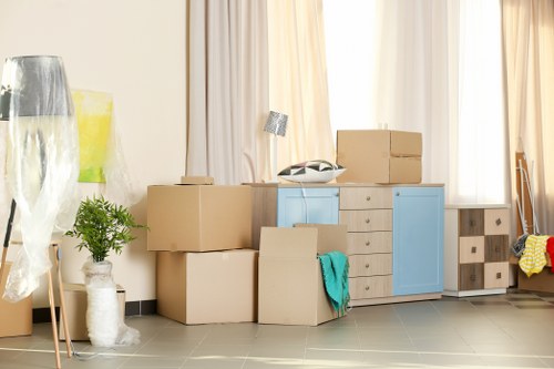 Furniture removal team handling a bulky sofa in a Finsbury Park flat