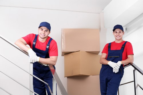 Professional moving help loading items into a van
