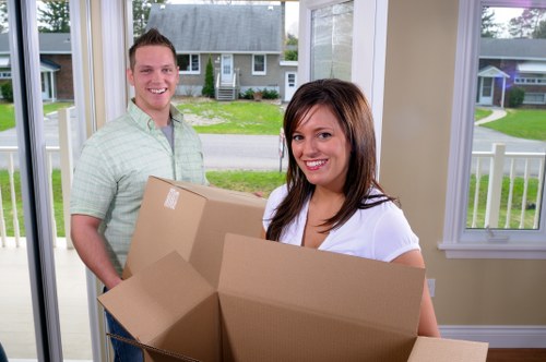 Removal team handling boxes and furniture during a van service