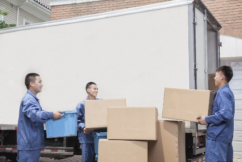 Local movers carrying boxes and household items for a Finsbury Park move