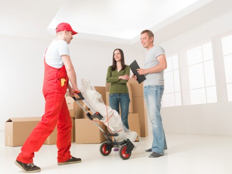 Insured man and van moving furniture carefully in Finsbury Park